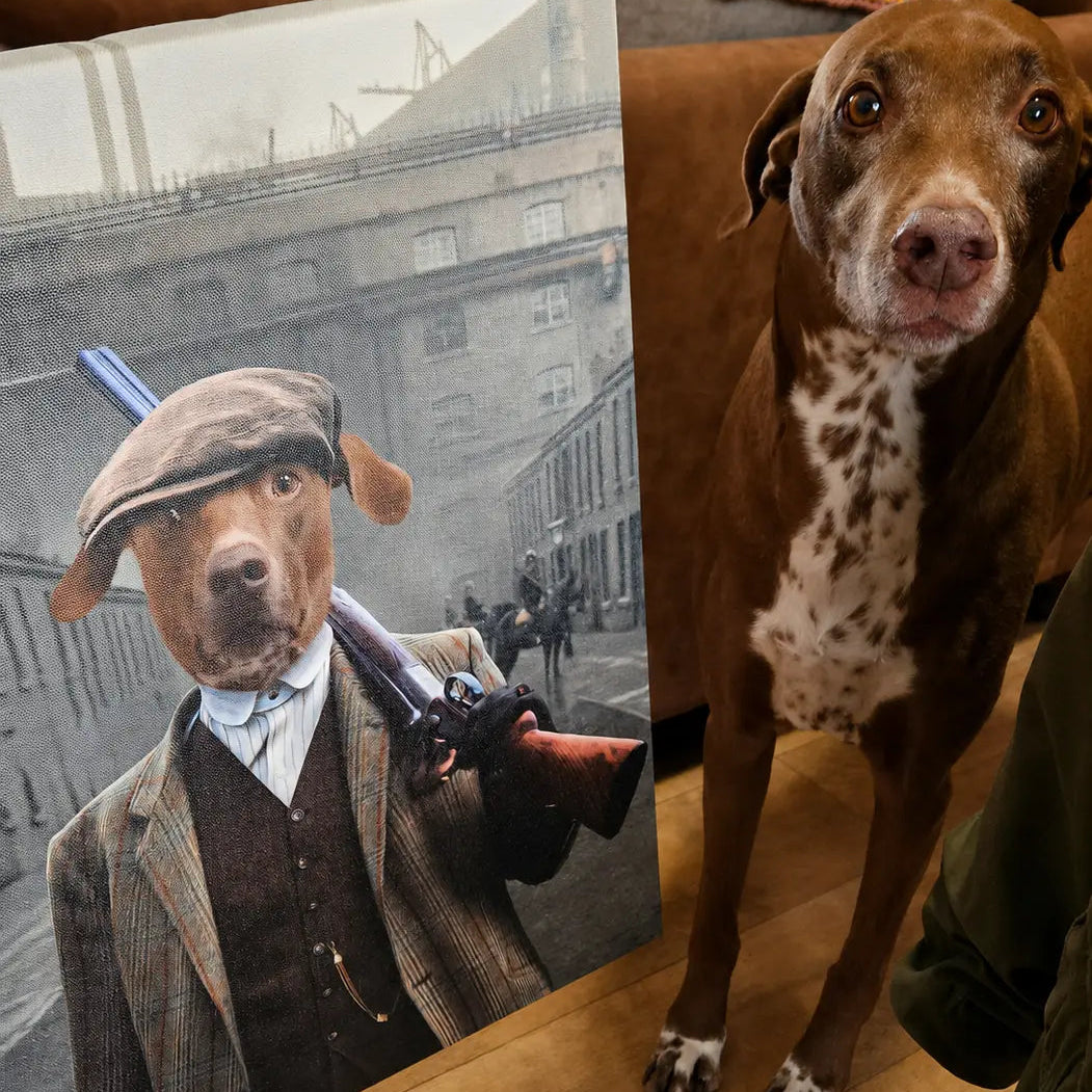 A large custom pet portrait canvas showing a dog dressed in vintage attire with a gun, displayed next to a real brown and white spotted dog in a living room setting.